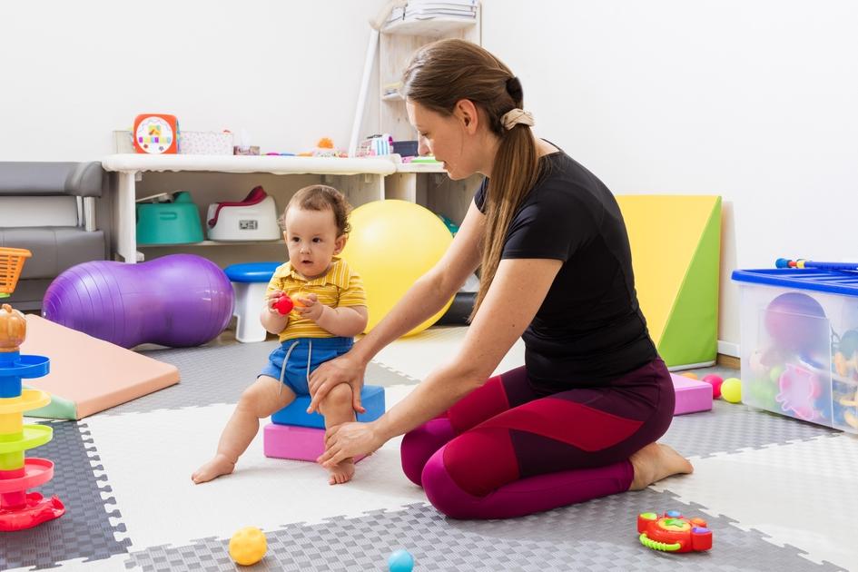 Physiotherapist,Assisting,A,Little,Child,With,Coordination,Disorders,During,Motor